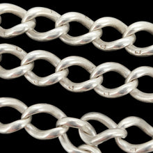Load image into Gallery viewer, Close-up of silver curb links with the lion passant stamps