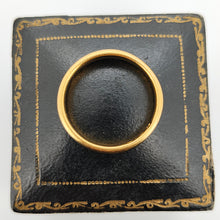 Load image into Gallery viewer, A plain yellow gold wedding band ring, on top of a black antique ring box