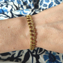 Load image into Gallery viewer, A yellow gold double link bracelet, modelled on a wrist