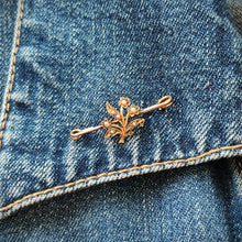 Load image into Gallery viewer, A yellow gold floral bar brooch with seed pearls, modelled on the collar of a denim jacket