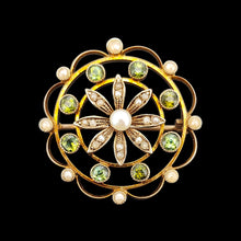 Load image into Gallery viewer, A circular brooch/pendant in yellow gold with peridots and pearls, with a flower to the centre, on a black background