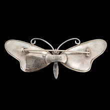 Load image into Gallery viewer, A large butterfly brooch in silver, on a black background