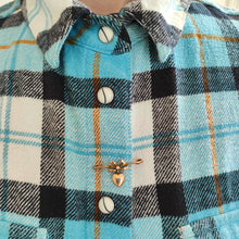 Load image into Gallery viewer, Antique 9ct Gold Heart and Bow Bar Brooch modelled in between the buttons of a blue and white gingham pattern shirt