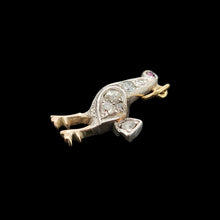 Load image into Gallery viewer, A diamond set bird charm in silver and yellow gold, with a ruby eye, on a black background
