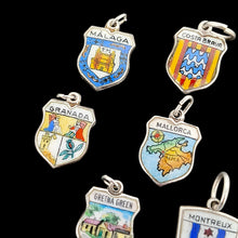 Load image into Gallery viewer, Enamelled silver shield charms depicting various towns, cities and countries, on a black background
