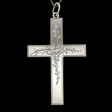 Load image into Gallery viewer, A silver cross pendant engraved with a bird and vines, with a curb link chain, on a black background