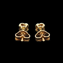 Load image into Gallery viewer, A pair of yellow gold diamond stud earrings, on a black background