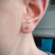 Load image into Gallery viewer, A yellow gold diamond stud earring modelled in an ear