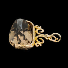 Load image into Gallery viewer, A spinning quartz fob pendant in yellow gold, on a black background