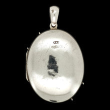 Load image into Gallery viewer, An oval silver locket pendant on a black background
