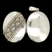 Load image into Gallery viewer, An oval silver locket pendant with acorn and oak leaf detailing, on a black background