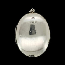 Load image into Gallery viewer, A silver oval locket pendant with a Victorian British Birmingham hallmark, on a black background