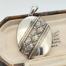 Load image into Gallery viewer, An oval silver locket pendant with acorn and oak leaf detailing, in an antique box