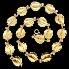 Load image into Gallery viewer, A leaf necklace in silver gilt, on a black background