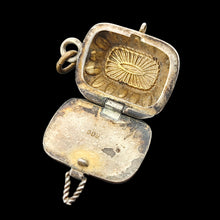 Load image into Gallery viewer, Vintage silver locket with engraved design on a black background