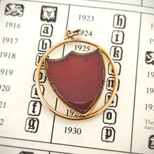Load image into Gallery viewer, Art Deco 9ct Gold Carnelian Shield Pendant on hallmark book