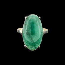 Load image into Gallery viewer, An oval nephrite jade ring in white and yellow gold, on a black background