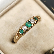 Load image into Gallery viewer, An emerald and diamond graduated five stone ring in yellow gold, in an antique ring box