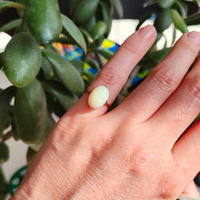 Load image into Gallery viewer, A single stone oval shaped, cabochon cut opal ring in rose gold, modelled on a hand