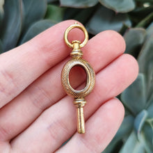 Load image into Gallery viewer, Antique Yellow Metal Watch Key Pendant in hand