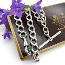 Load image into Gallery viewer, A silver curb link Albert chain with lobster clasp and T-bar, with purple flowers and a Penhaligons box
