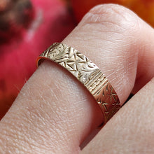 Load image into Gallery viewer, Gold ring with intricate design on a finger against a blurred background
