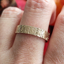 Load image into Gallery viewer, Gold ring with intricate design on a finger against a blurred background
