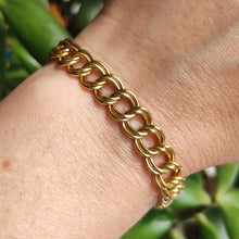 Load image into Gallery viewer, A yellow gold double link bracelet, modelled on a wrist
