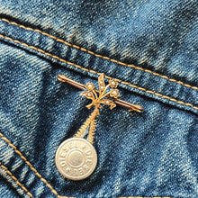 Load image into Gallery viewer, A yellow gold floral bar brooch with seed pearls, modelled on a DIESEL denim jacket pocket

