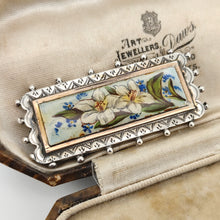 Load image into Gallery viewer, An oblong silver hobnail bead border brooch with an enamelled central plaque displaying flowers, in an antique box
