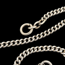 Load image into Gallery viewer, Close-up of the curb links and end ring of a chain necklace, on a black background
