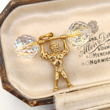 Load image into Gallery viewer, A yellow gold weightlifter charm pendant with a crystal barbell, in an antique box
