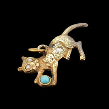 Load image into Gallery viewer, A yellow metal cat playing with a blue ball charm, on a black background
