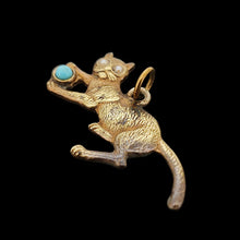 Load image into Gallery viewer, A yellow metal cat playing with a blue ball charm, on a black background
