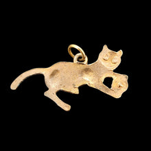 Load image into Gallery viewer, A yellow metal cat playing with a ball charm, on a black background
