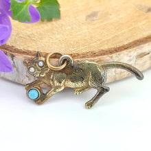 Load image into Gallery viewer, A yellow metal cat playing with a blue ball charm
