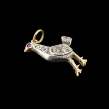 Load image into Gallery viewer, A diamond set bird charm in silver and yellow gold, with a ruby eye, on a black background
