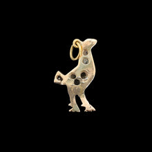 Load image into Gallery viewer, A diamond set bird charm in silver and yellow gold, on a black background
