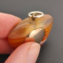 Load image into Gallery viewer, Antique Agate Heart Compass Pendant in hand, chip to top
