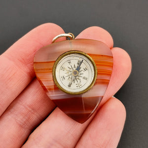 Antique Agate Heart Compass Pendant in hand