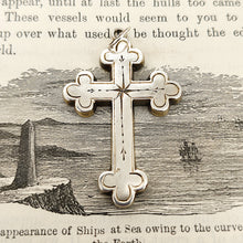 Load image into Gallery viewer, Victorian Sterling Silver Cross Pendant shown from the front, on an illustrated book background
