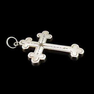 Victorian Sterling Silver Cross Pendant  shown from the side, on a black background