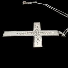 Load image into Gallery viewer, A silver cross pendant engraved with a bird and vines, with a curb link chain, on a black background
