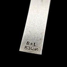Load image into Gallery viewer, A silver cross pendant stamped S&amp;L 830S, on a black background
