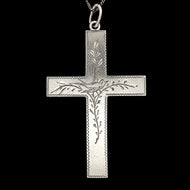 A silver cross pendant engraved with a bird and vines, with a curb link chain, on a black background