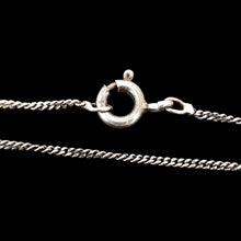 Load image into Gallery viewer, A close-up of a silver curb link chain with bolt ring clasp, on a black background
