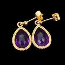Load image into Gallery viewer, A pair of pear shaped amethyst drop earrings in yellow gold rope edge mounts, on a black background
