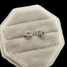Load image into Gallery viewer, A pair of yellow gold diamond stud earrings, in a light coloured jewellery box, on a black background

