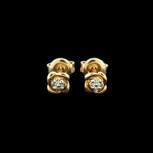 Load image into Gallery viewer, A pair of yellow gold diamond stud earrings, on a black background
