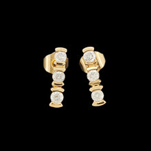 Load image into Gallery viewer, A pair of yellow gold three stone diamond bar set stud earrings, on a black background
